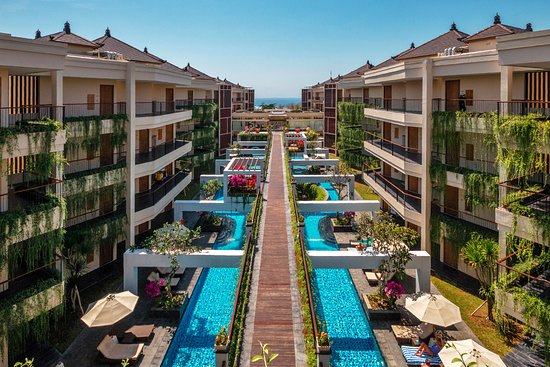 Aerial view of Vouk Hotel & Suites with a large pool and balconied wings in Nusa Dua