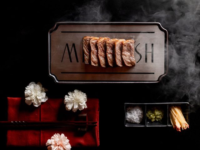 Miss Fish signage on a dark textured wall at the restaurant entrance