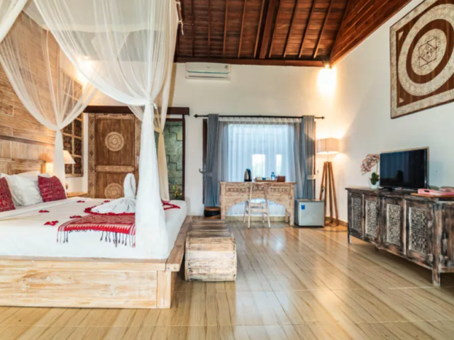 Villa suite with a four-poster bed and console at Taro Hotel