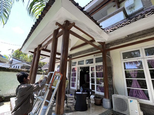 Renovation work in progress near a timber pergola at Villa Gloria