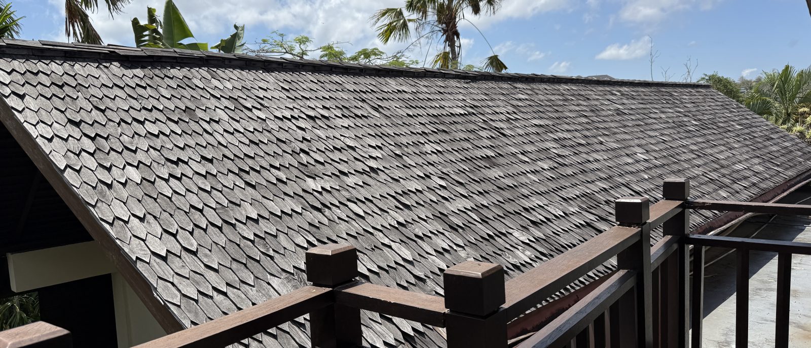 Tiled villa roof and palm trees during renovation works at Karma Kandara, Ungasan